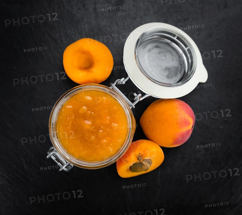 Portion of Apricot Jam as detailed close up shot on a slate slab (selective focus)