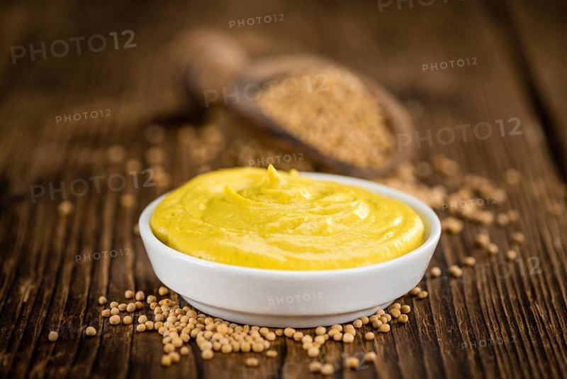 Mustard on a vintage background as detailed close-up shot (selective focus)