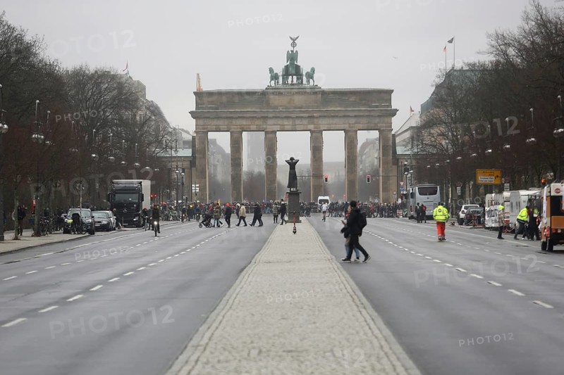 People crossing the road near the Brandenburg Gate on a day of political protest. Berlin, Germany, Europe