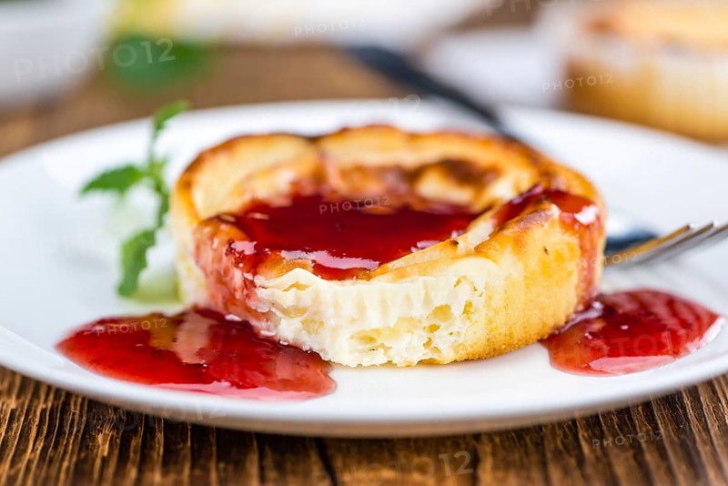 Cheesecake with berry Sacue on a vintage background as detailed close-up shot (selective focus)