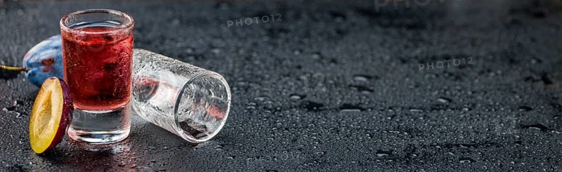 Some Plum Liqueur on a vintage slate slab, selective focus