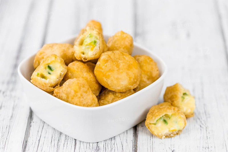 Homemade Cheese Nuggets (with Chilis) on vintage background (selective focus, close-up shot)