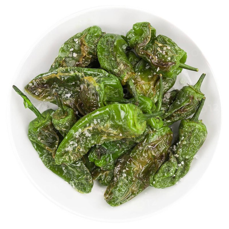 Portion of Pimientos de Padron as detailed close-up shot isolated on white background