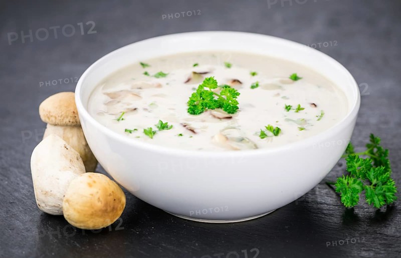 Porcini Soup on a vintage slate slab as detailed close-up shot, selective focus