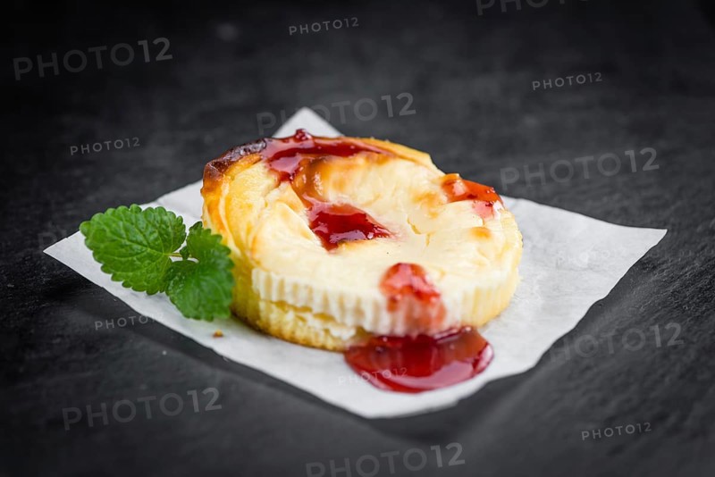 Cheesecake with Sauce on a vintage slate slab (close-up shot, selective focus)