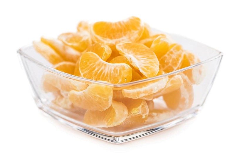 Portion of tangerines (close-up shot, selective focus) isolated on white background
