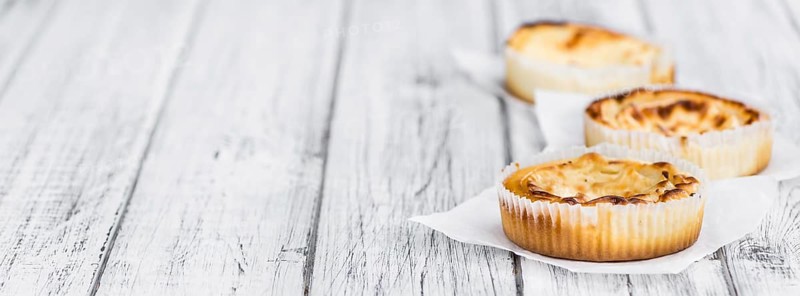 Fresh made Mini Cheesecake on a vintage background (close-up shot)