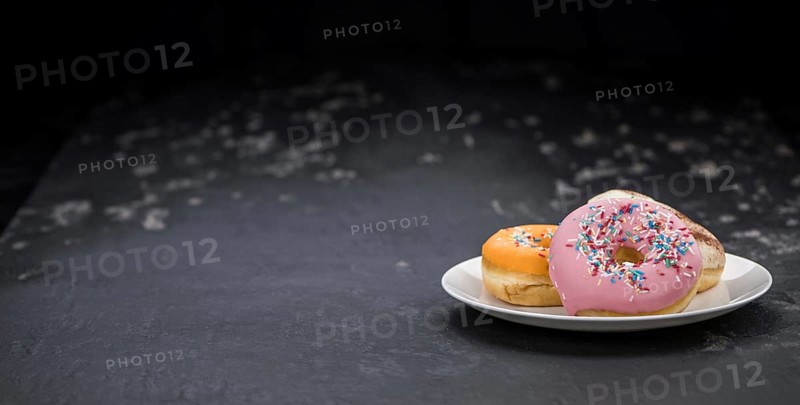 Portion of some Donuts as detailed close-up shot (fresh made, selective focus)