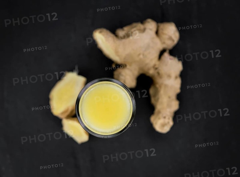Fresh made Ginger Drink on a slate slab (close-up shot, selective focus)