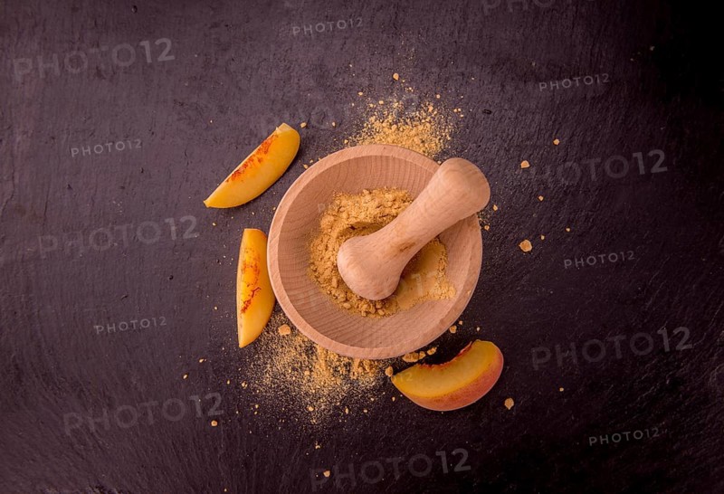Peach powder on a vintage slate slab as detailed close-up shot, selective focus