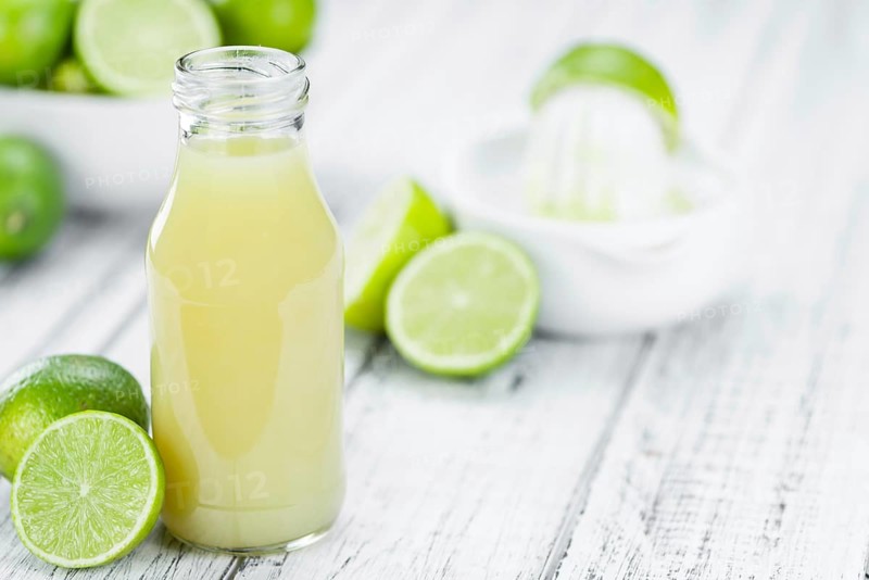 Portion of fresh Lime Juice (close-up shot, selective focus)