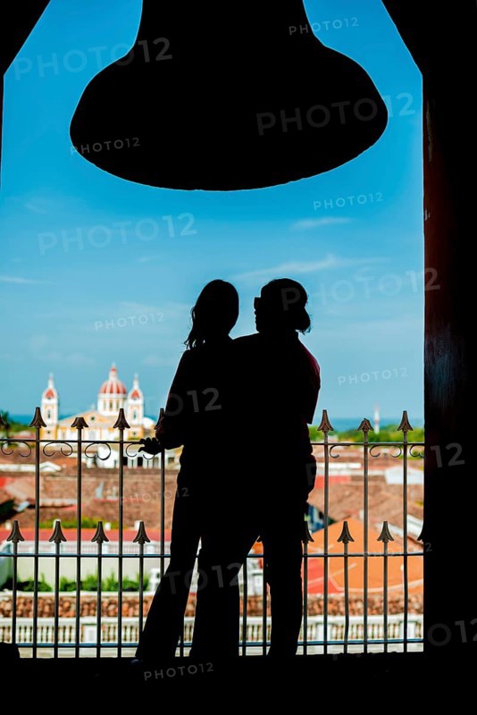 Silhouette of a tourist couple contemplating the Granada cathedral from the La Merced viewpoint