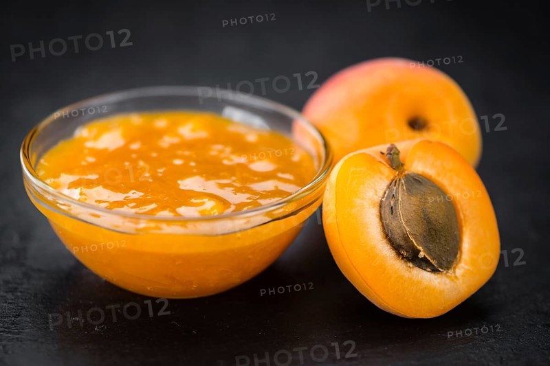 Portion of Apricot Jam as detailed close up shot on a slate slab (selective focus)