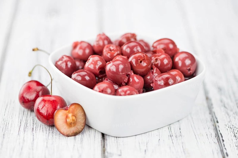 Preserved Cherries on a vintage background as detailed close-up shot, selective focus