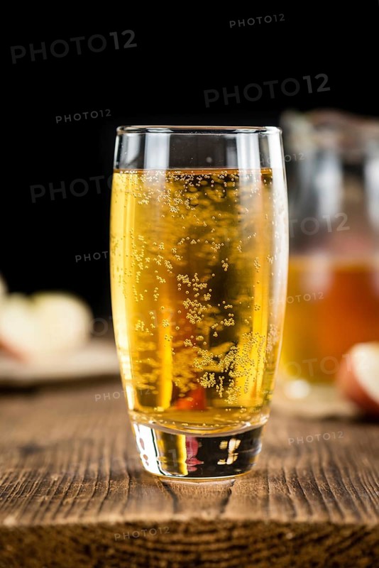 Apple Cider on an old wooden table as detailed close-up shot (selective focus)