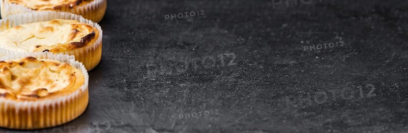 Some fresh Cheesecake on a vintage slate slab (selective focus, close-up shot)