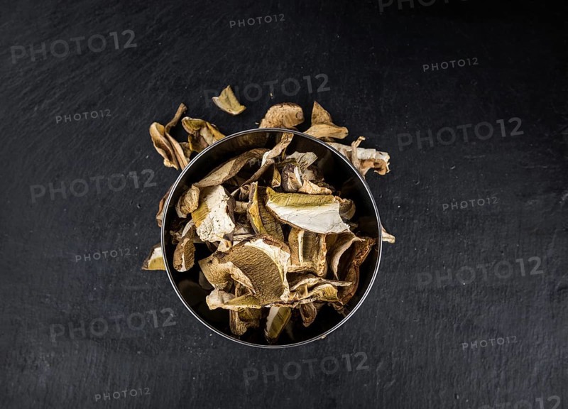 Some Dried Porcinis on a slate slab as detailed close-up shot, selective focus
