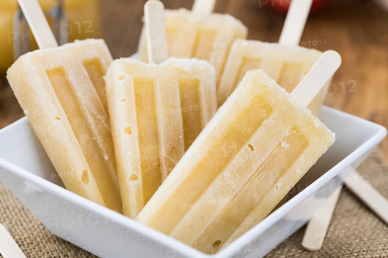 Fresh made Apple Popsicles (selective focus, close-up shot) on a vintage background
