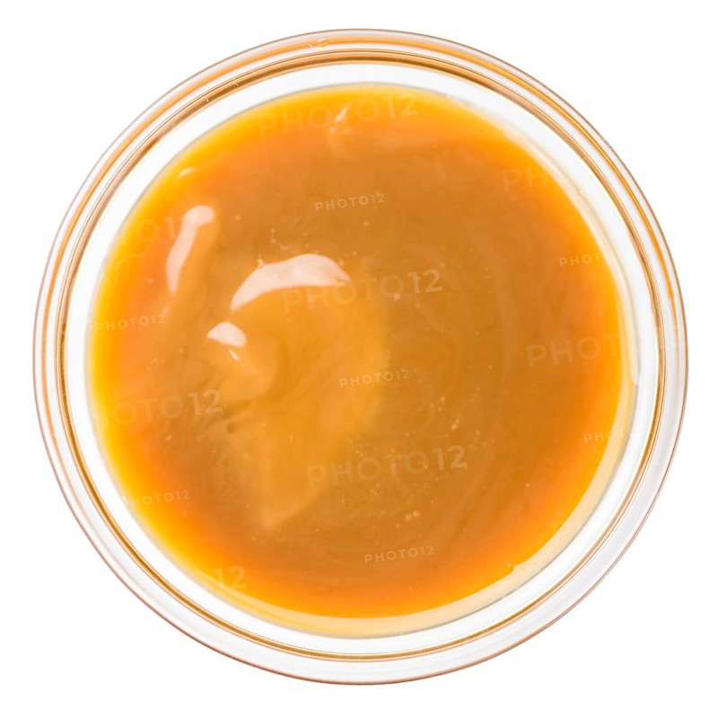 Caramel Sauce on a vintage slate slab (close-up shot, selective focus)