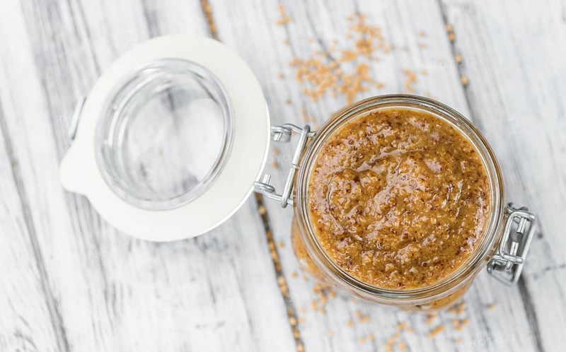 Fresh made German Cuisine (sweet Mustard) on a vintage background (close-up shot)