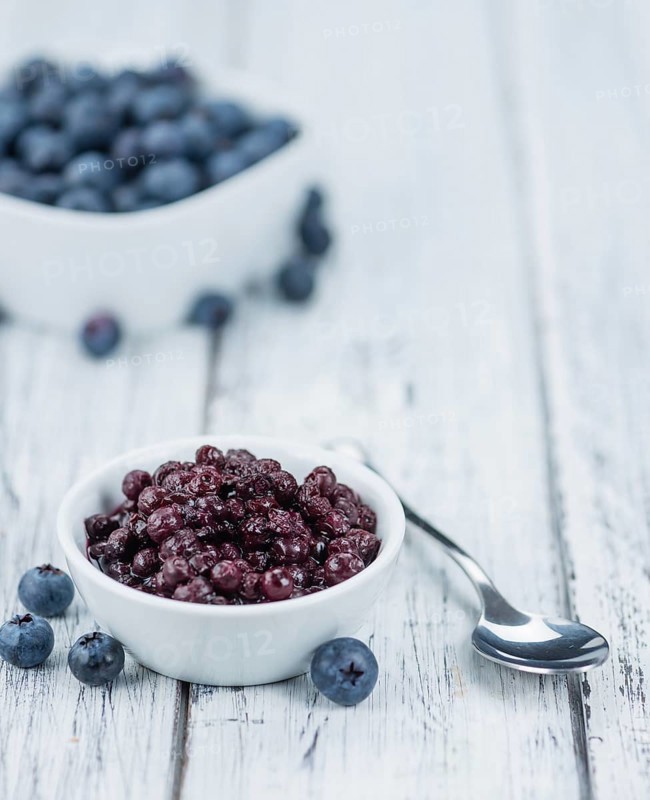 Preserved Blueberries on a vintage background as detailed close-up shot, selective focus