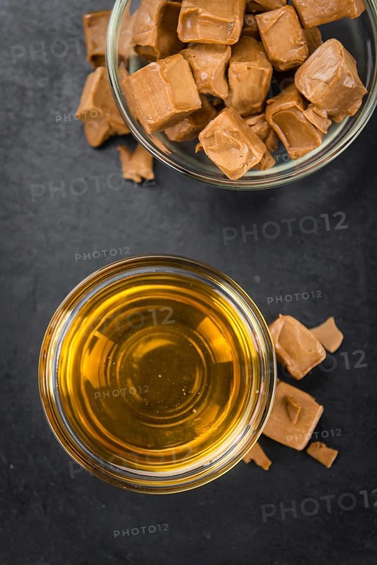 Caramel Sirup on a vintage background as detailed close-up shot (selective focus)