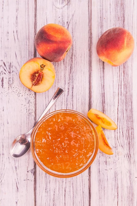 Homemade Peach Jam on an wooden table as detailed close-up shot, selective focus