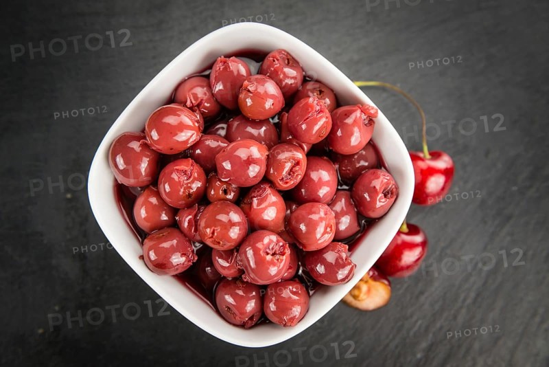 Fresh made Canned Cherries on a vintage background as detailed close-up shot