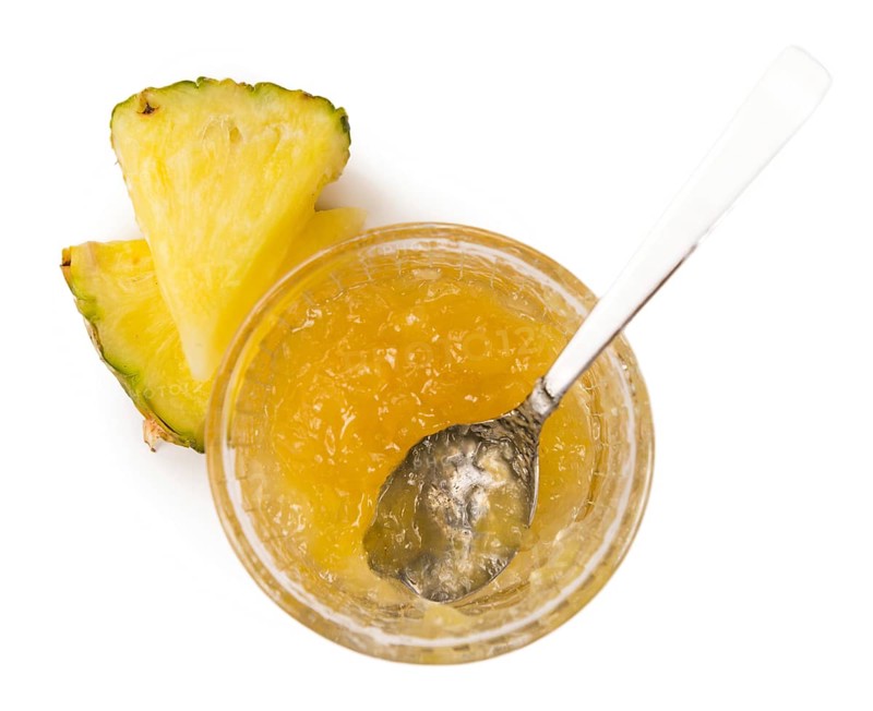 Pineapple Jam isolated on white background, selective focus, close-up shot