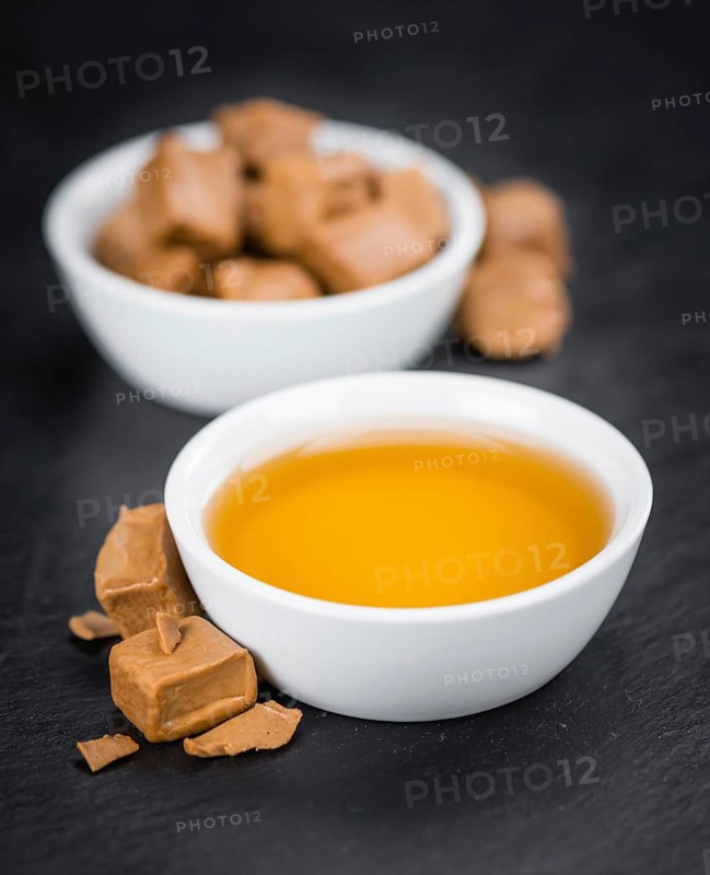 Portion of fresh Caramel Sirup (close-up shot, selective focus)