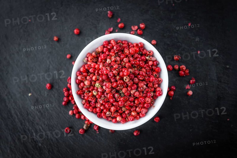 Pink Peppercorns on a vintage background as detailed close-up shot, selective focus