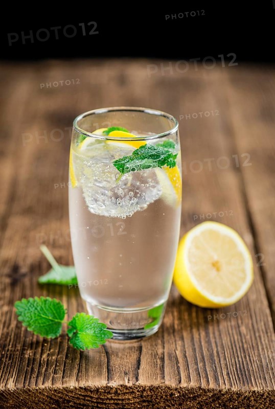 Lemonade on a vintage background as detailed close-up shot (selective focus)
