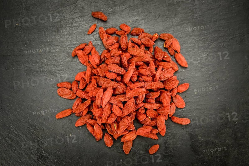 Fresh made Dried Goji Berries on a vintage background (close-up shot)