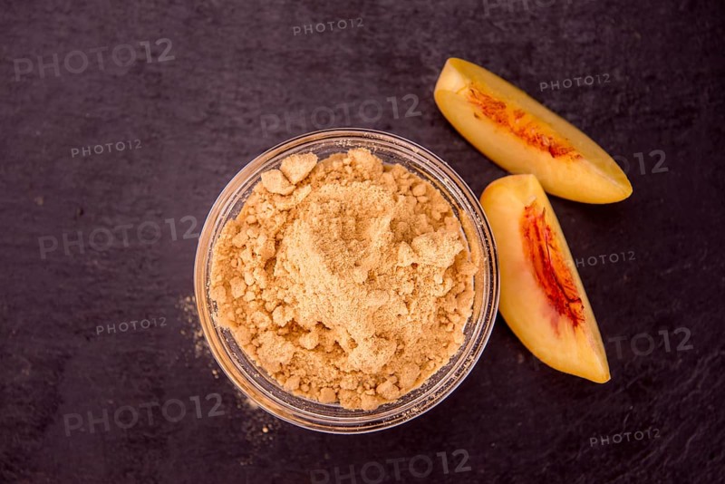 Peach powder on a vintage slate slab as detailed close-up shot, selective focus