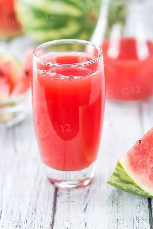 Homemade Watermelon Smoothie on an wooden table (selective focus) as detailed close-up shot