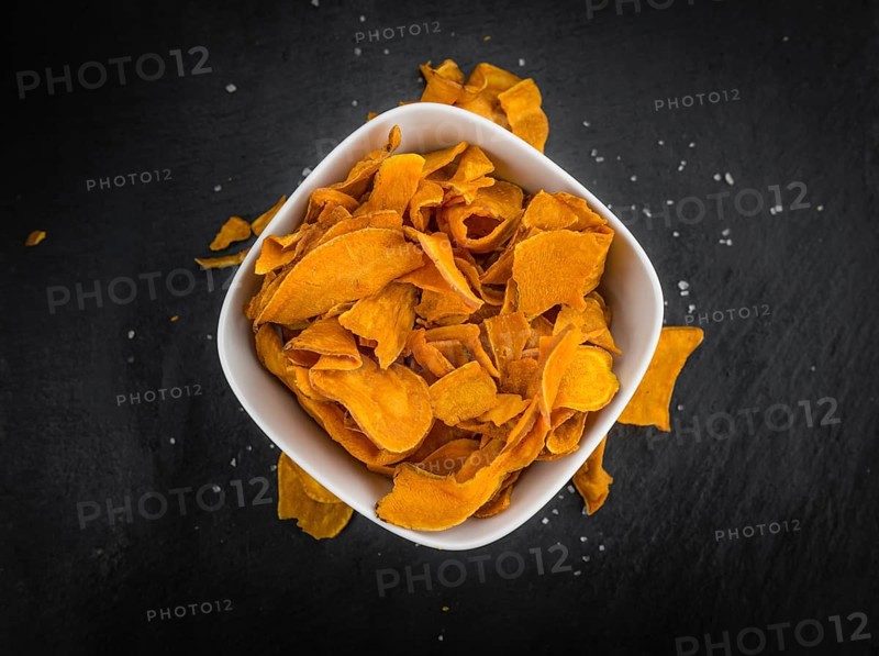 Homemade Sweet Potato Chips on vintage background selective focus, close-up shot