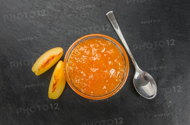 Portion of Peach Jam on a rustic slate slab, selective focus, close-up shot