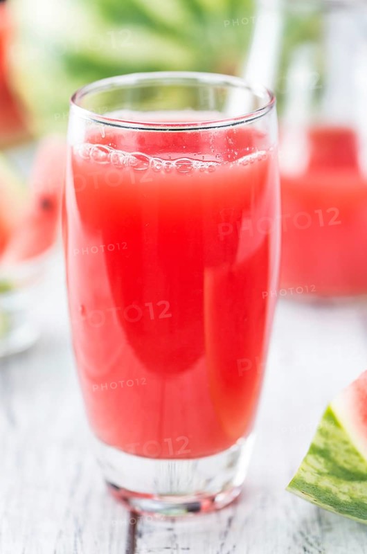 Homemade Watermelon Smoothie on an wooden table (selective focus) as detailed close-up shot