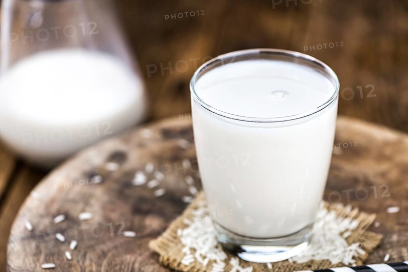 Wooden table with Rice Milk (detailed close-up shot, selective focus)