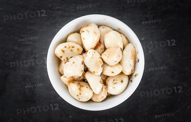 Fresh made Garlic (preserved) on a vintage background (close-up shot)