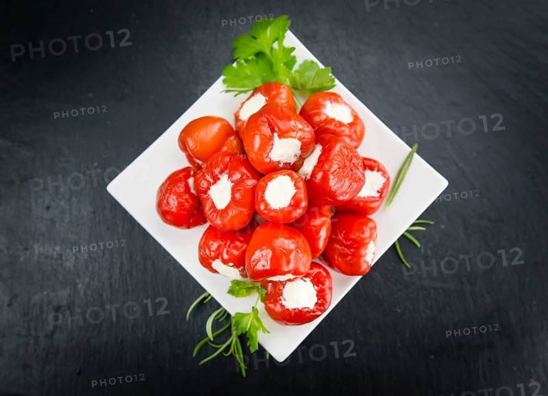Homemade Filled Pimientos on vintage background (selective focus, close-up shot)