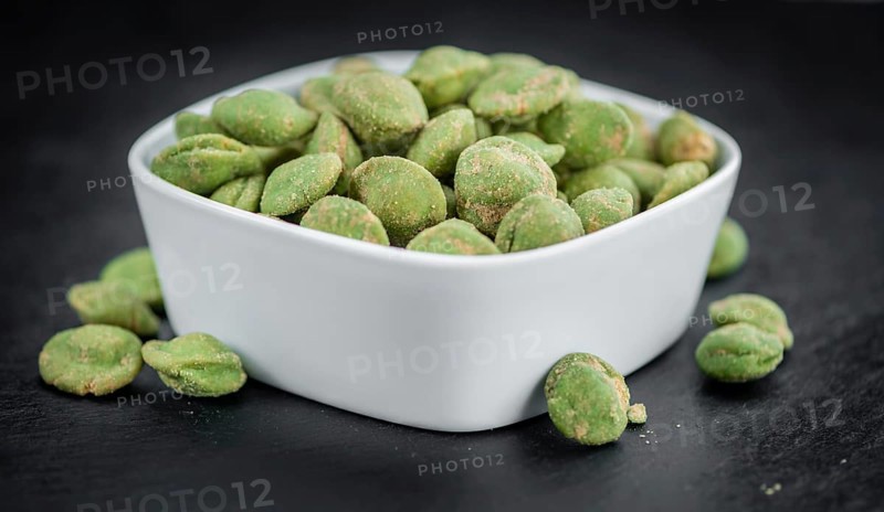 Homemade Peanuts (with Wasabi flavor) on vintage background (selective focus, close-up shot)