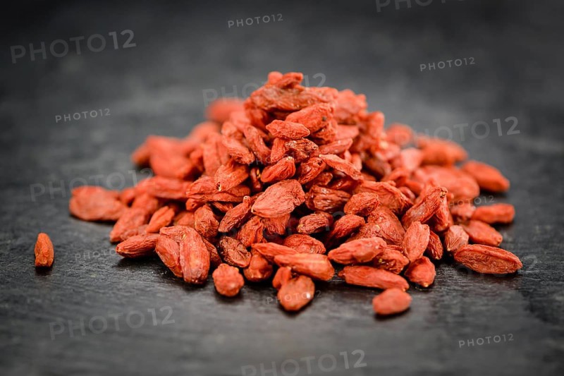 Portion of Dried Goji Berries on a rustic slate slab (selective focus, close-up shot)