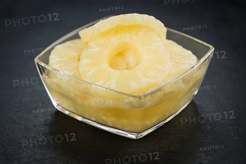Fresh made Preserved Pineapple Rings on a vintage background as detailed close-up shot
