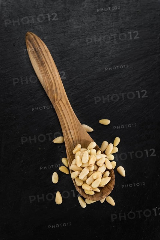Portion of fresh Pine Nuts (close-up shot, selective focus)