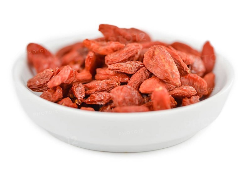 Goji Berries (dried) isolated on white background (selective focus, close-up shot)