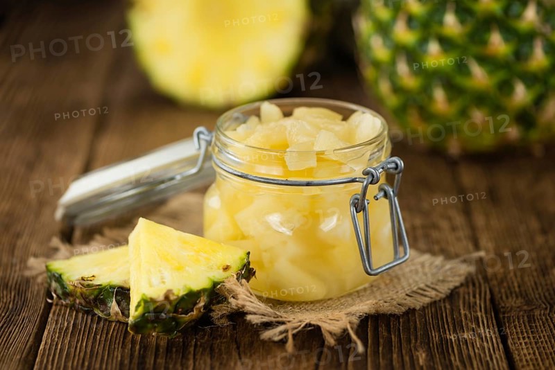 Fresh made Chopped Pineapple (preserved) on an old and rustic wooden table, selective focus, close-up shot