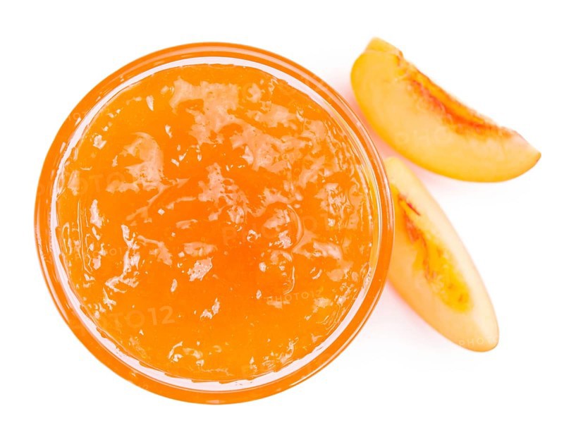 Portion of Peach Jam on a rustic slate slab, selective focus, close-up shot