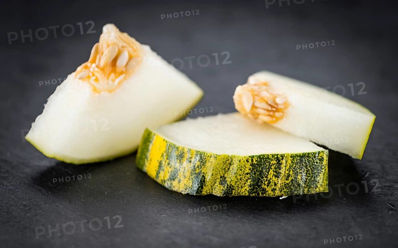 Portion of Futuro Melons as detailed close up shot on a slate slab (selective focus)