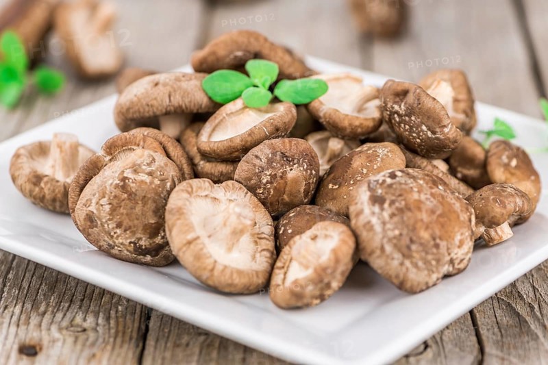 Portion of fresh Shiitake mushrooms close-up shot, selective focus